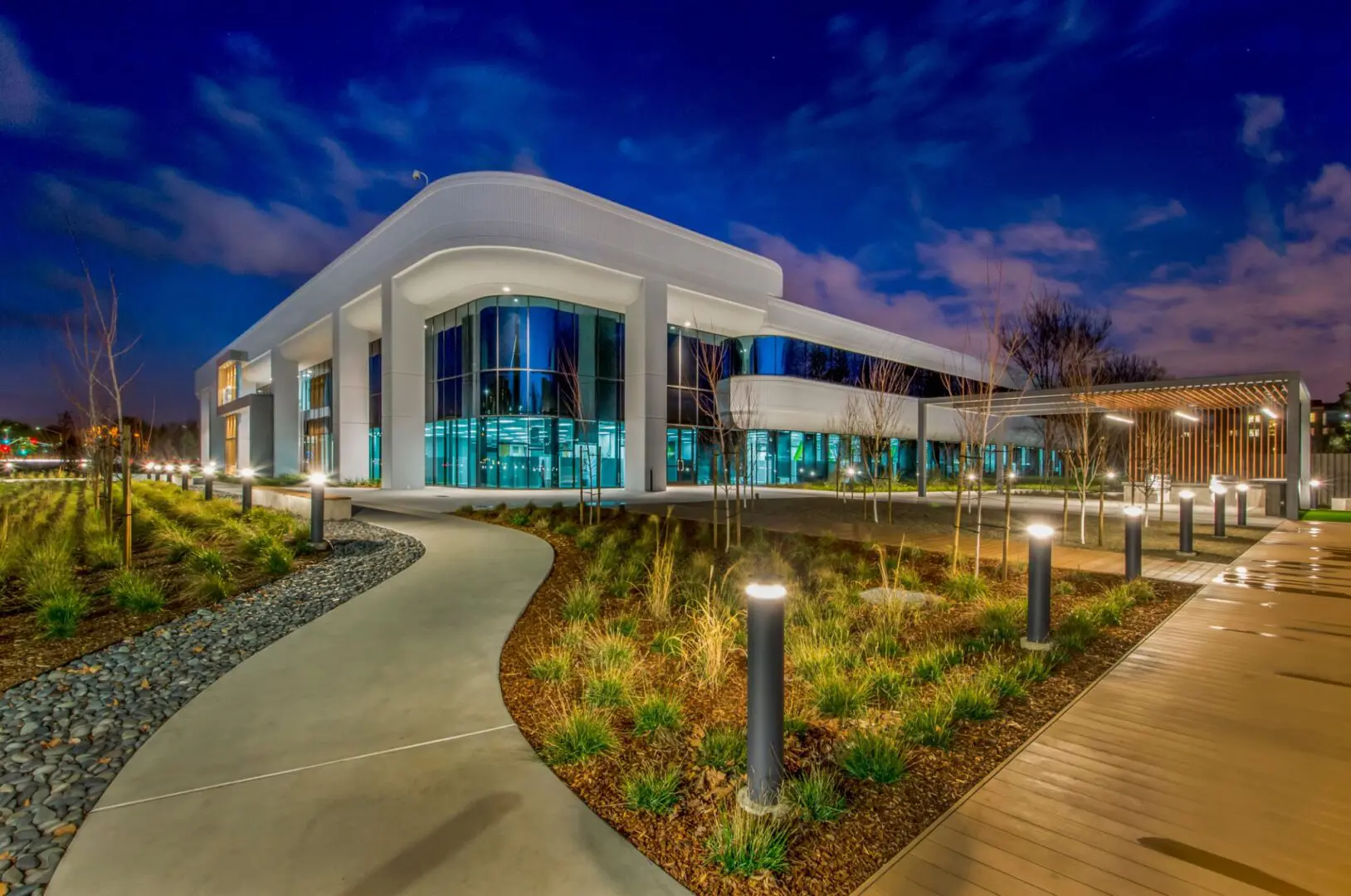 Modern building with illuminated pathway at night.