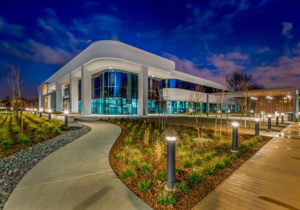 Modern building with illuminated pathway at night.